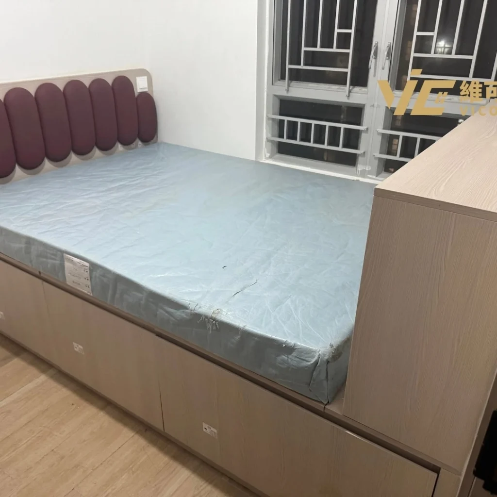 Storage bed with upholstered headboard and light blue mattress