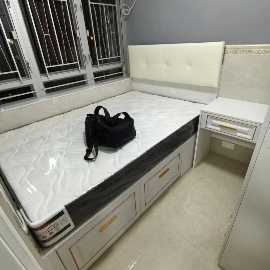 White storage bed with cushioned headboard and drawers
