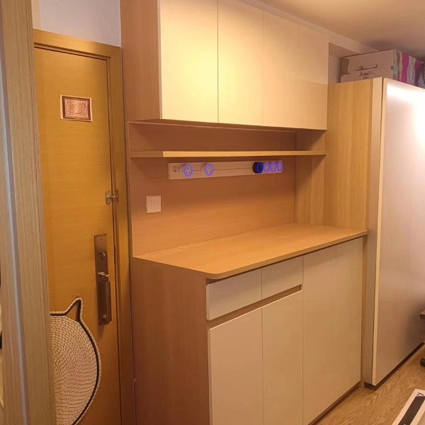 Light wood upper and base cabinets with counter and power sockets