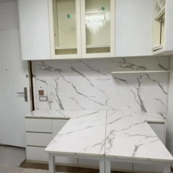 White marble-pattern kitchen cabinets with dining table