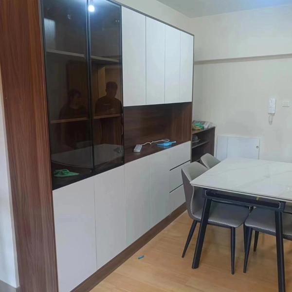 White and wood cabinet with glass doors beside a dining table