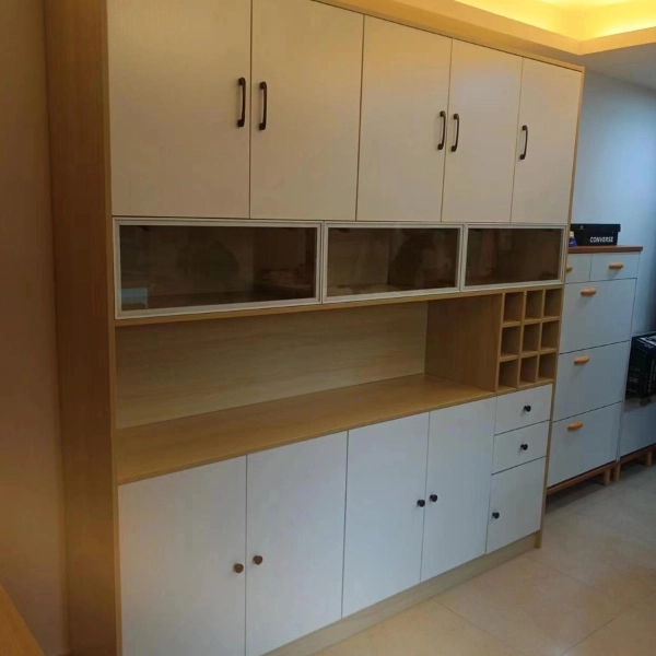 White cabinet with glass doors and wine rack above drawers