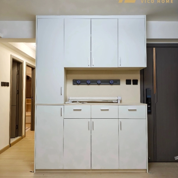 White kitchen wall cabinet with hooks and paper roll holder