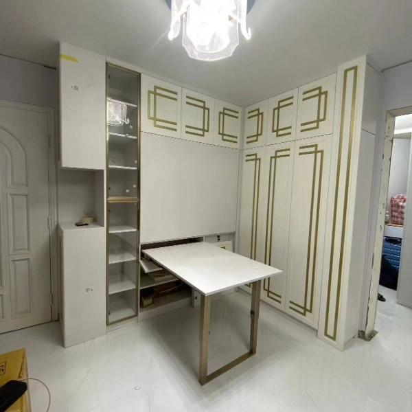 White cabinet with gold trim, desk, shelving and wardrobe