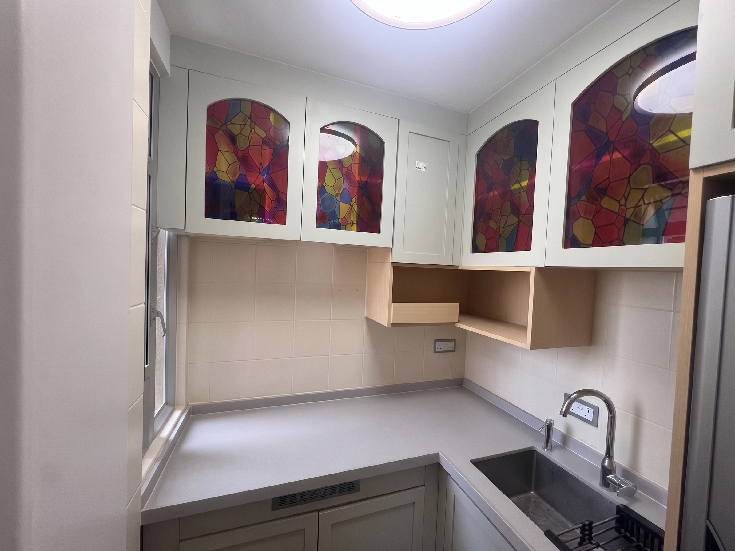 Yu Hing Court kitchen showcase: L-shaped custom cabinets with colorful mosaic glass doors and integrated appliance tower